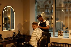 Face of Grooming barber performing hair cut on client in York St grooming lounge