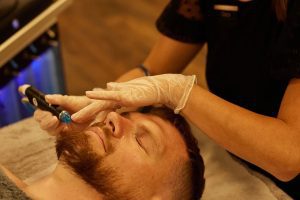 Gentleman receiving a hydrafacial from Face of Man dermal therapist