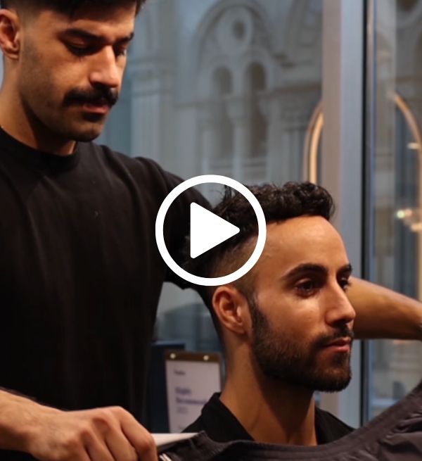 Barber giving hair cut